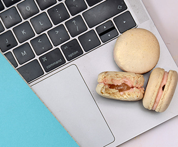 macarons half eaten sitting on laptop