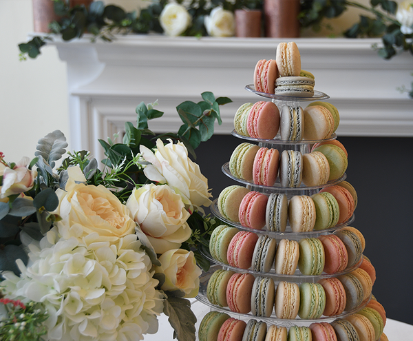 green, pink, blue and white macaron tower with flowers