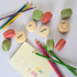 End of term teacher gift box with thank you message on vanilla macarons and red and green macaron flavours.