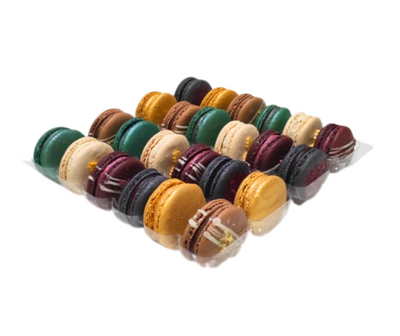 Assorted colorful macarons in a clear plastic bag on a white background