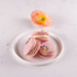 Dark chocolate rose macarons with soft pink shells and lilac royal icing flower detail, designed for a luxury Mother’s Day gift