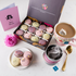 Luxury Mother’s Day macaron gift box filled with floral peach, raspberry and rose flavours, styled with tea and spring flowers for elegant gifting.
