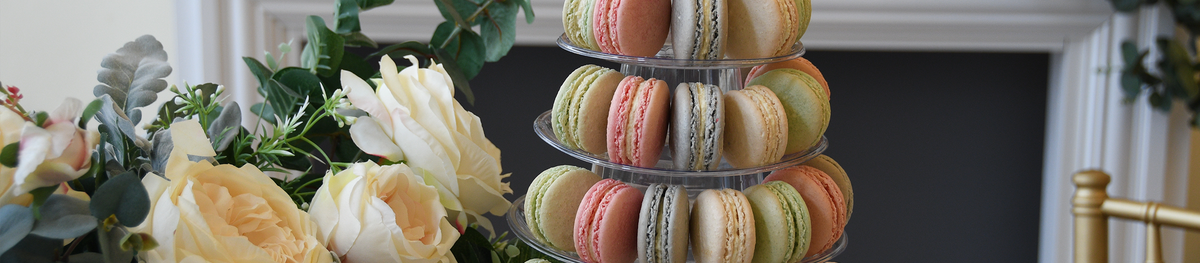 green, pink, blue and white macaron tower with flowers
